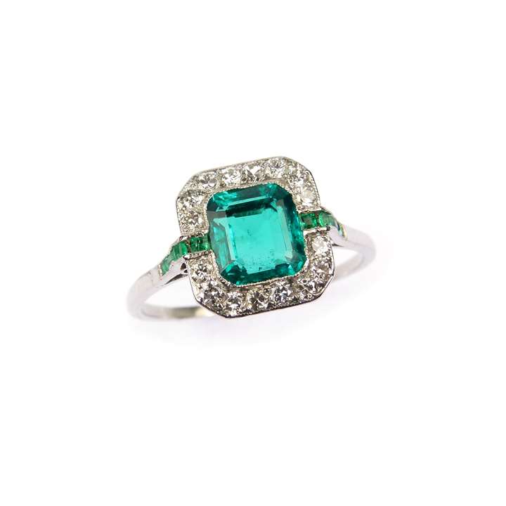 Art Deco emerald and diamond cluster ring with the 1.67ct trap-cut rectangular Colombian emerald